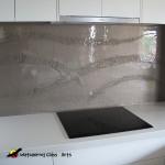 Bronze glass kitchen splashback with dry river design